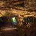Il tunnel ci conduce, dopo qualche metro, nellambiente pi suggestivo di tutto lipogeo. La fioca luce che trapela da unapertura ci permette di ammirare uno spesso pilastro centrale e le arcate superiori che sorreggono lintera struttura
